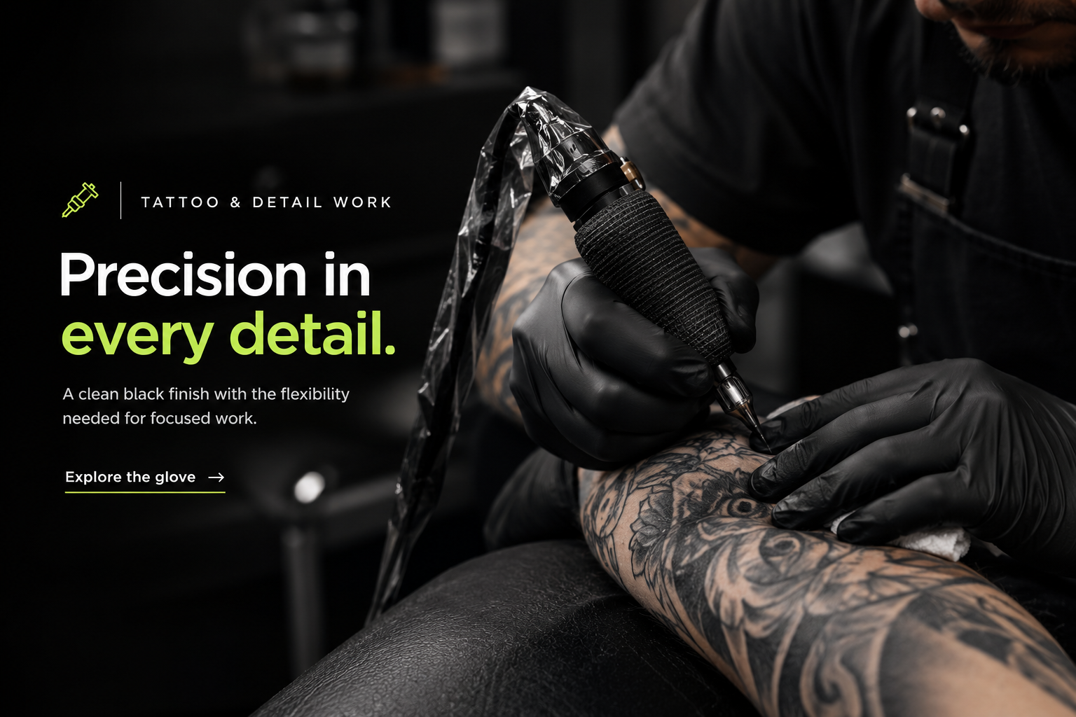 Tattoo artist wearing black nitrile gloves
